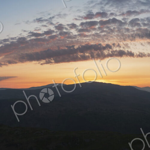 Sunset over the Mawddach Estuary, silhouettes of the hills, and view to the sea. Sunset over the Mawddach Estuary, silhouettes of the hills, and view to the sea.