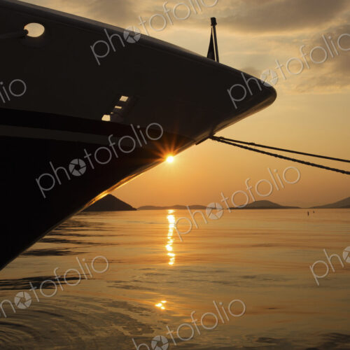 Sunset over the Mediterranean Sea and the view of a ship's bow.