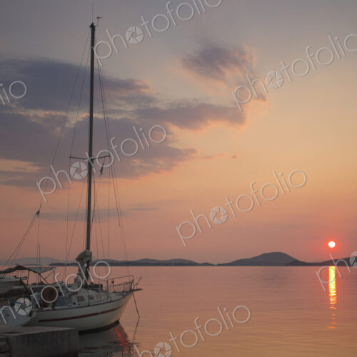 Sunset over the Mediterranean Sea. A yacht moored at a jetty. Sunset over the Mediterranean Sea. A yacht moored at a jetty.