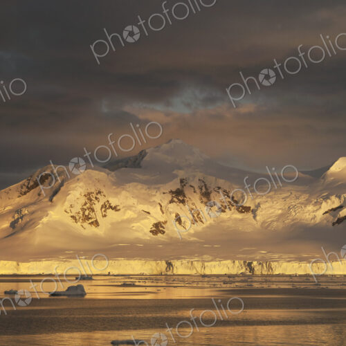 Sunset over the mountainous landscape of Antarctica. Sunset over the mountainous landscape of Antarctica.