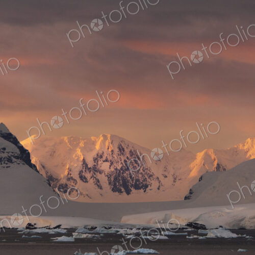 Sunset over the mountainous landscape of Antarctica. Sunset over the mountainous landscape of Antarctica.