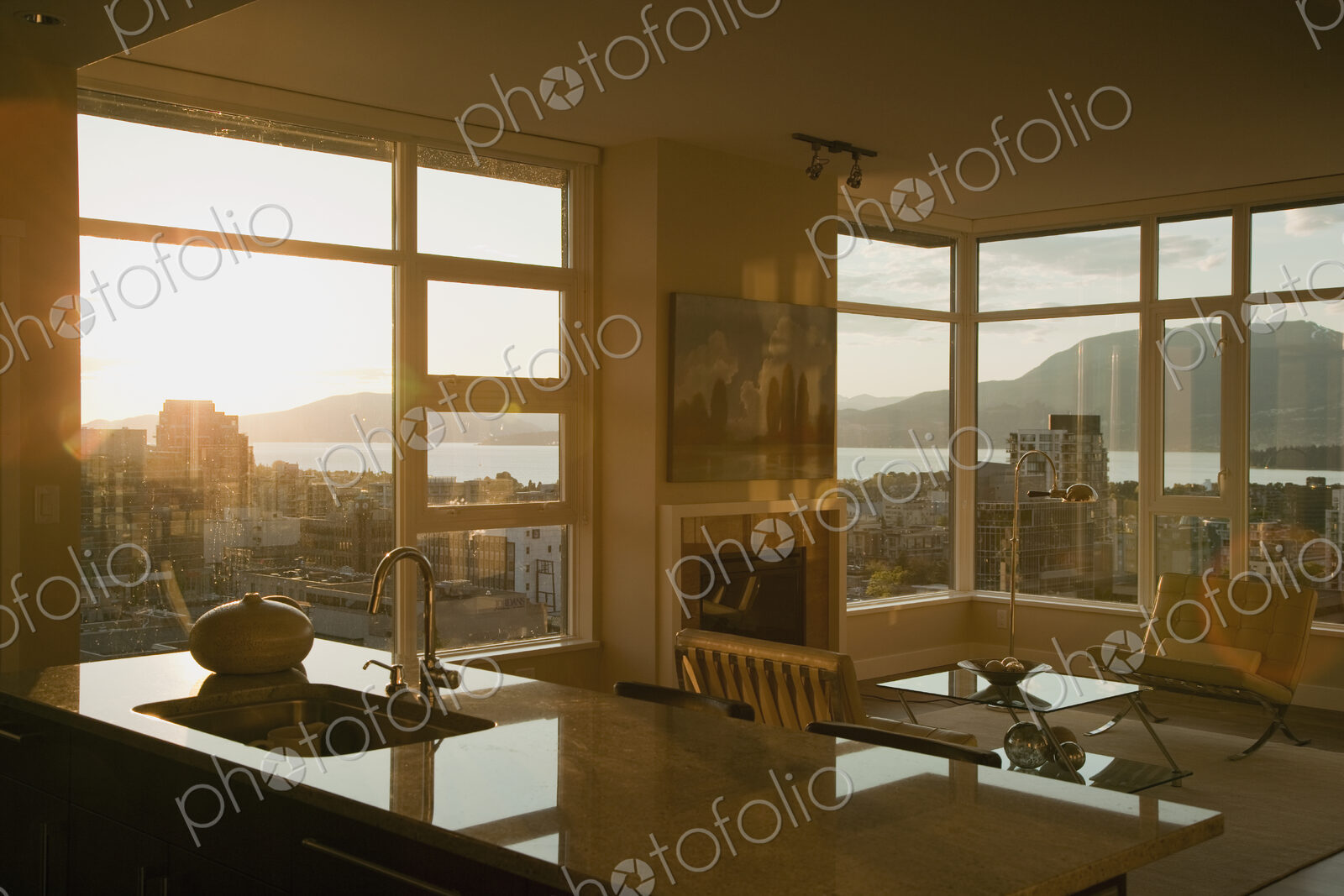 Sunset through windows of open plan apartment.
