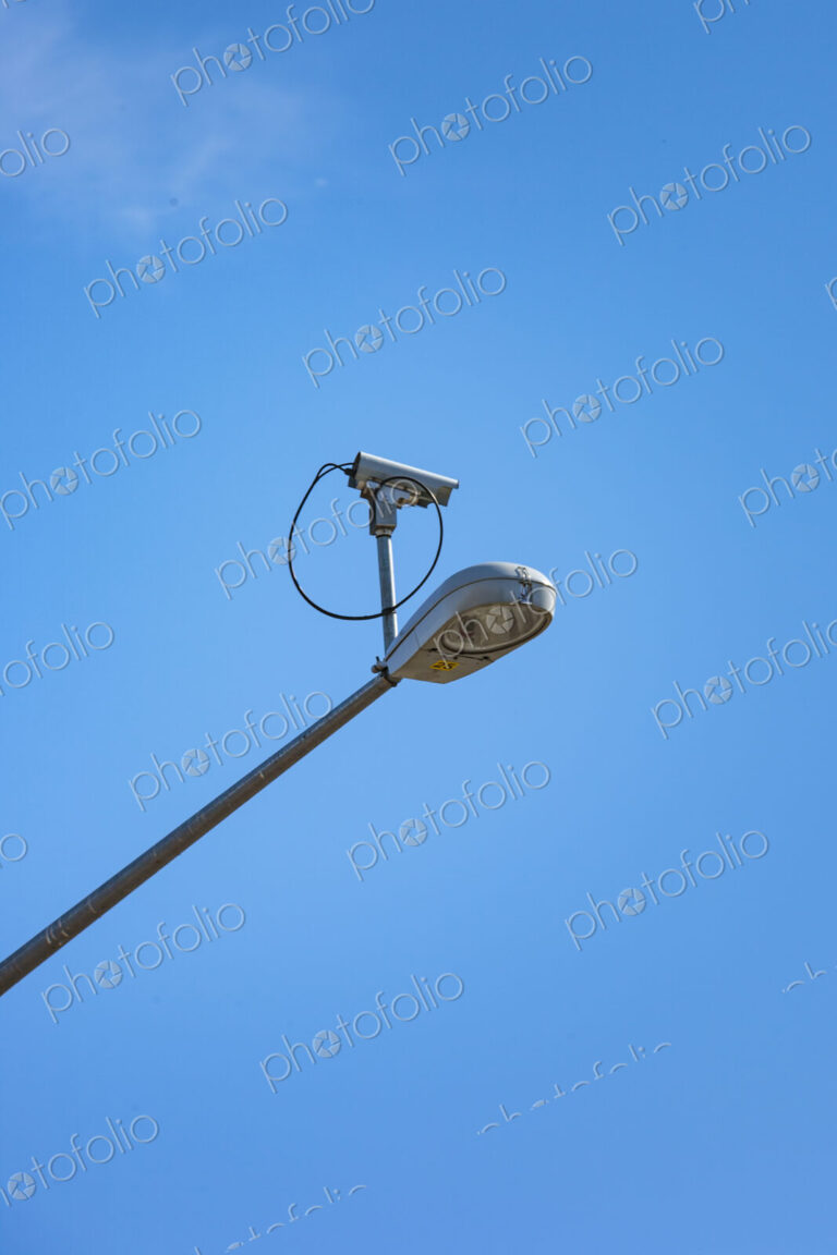 Surveillance security camera mounted on street lamp, USA