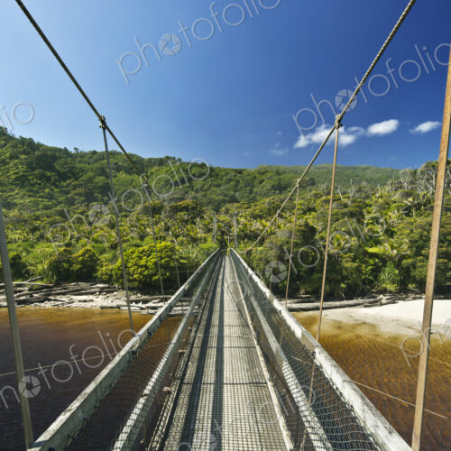 Suspension bridge over tropical beach