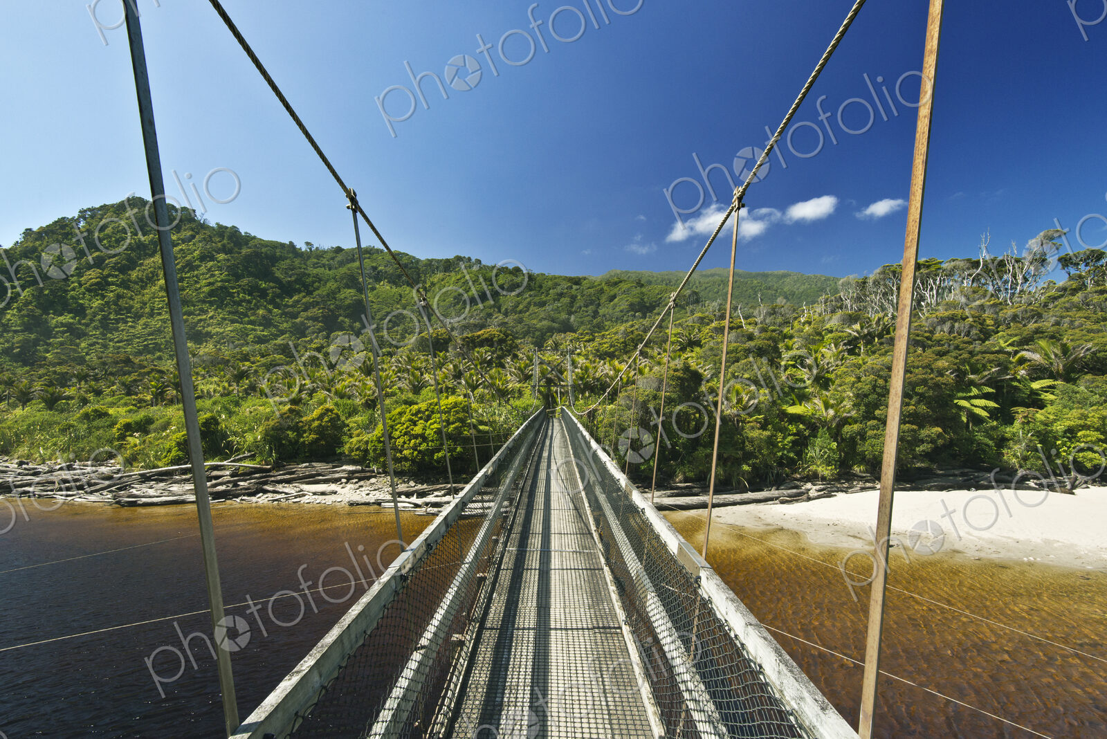 Suspension bridge over tropical beach