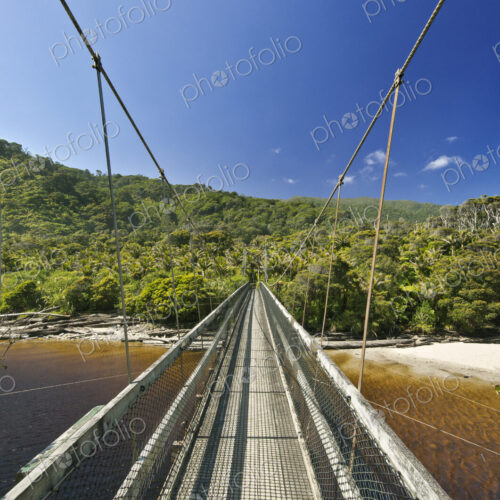 Suspension bridge over tropical beach