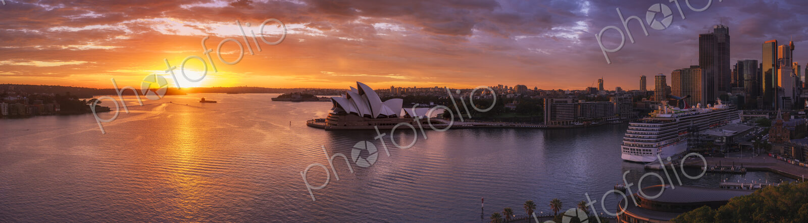 Sydney harbour with cruise ship docked at dawn.