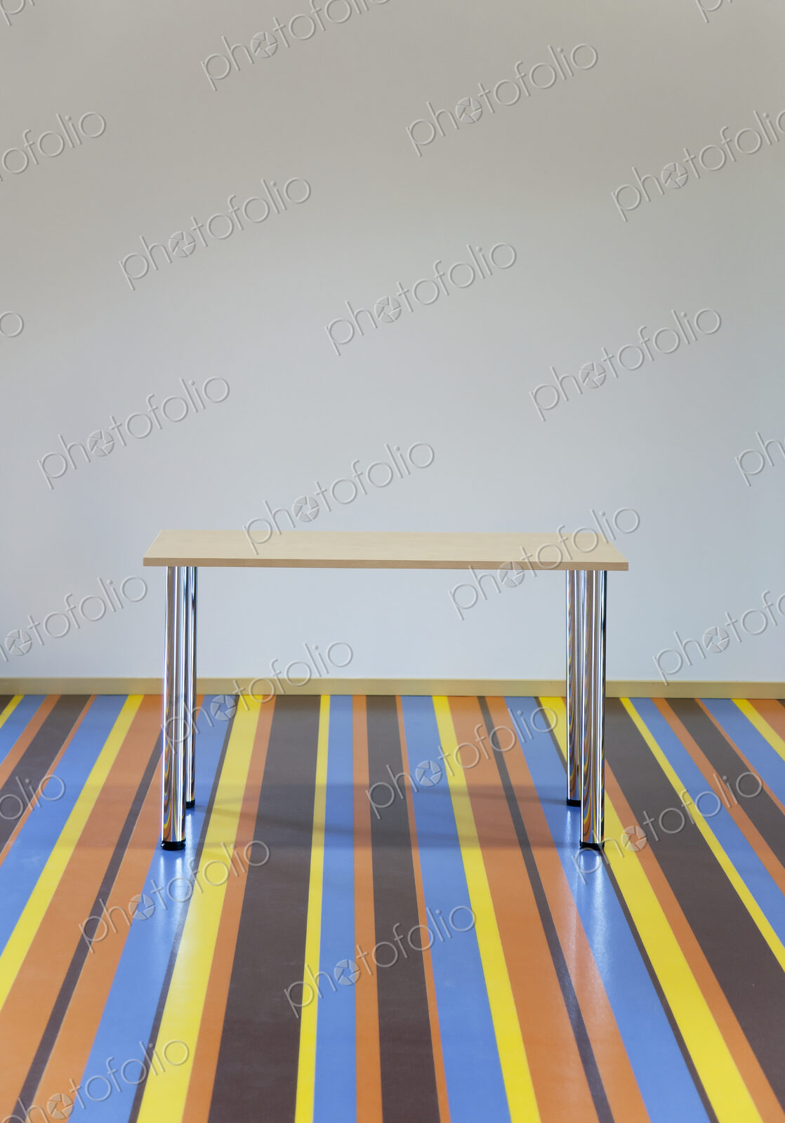 Table Standing on a Striped Floor