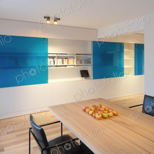 Table and chairs near wall fixtures in modern dining room