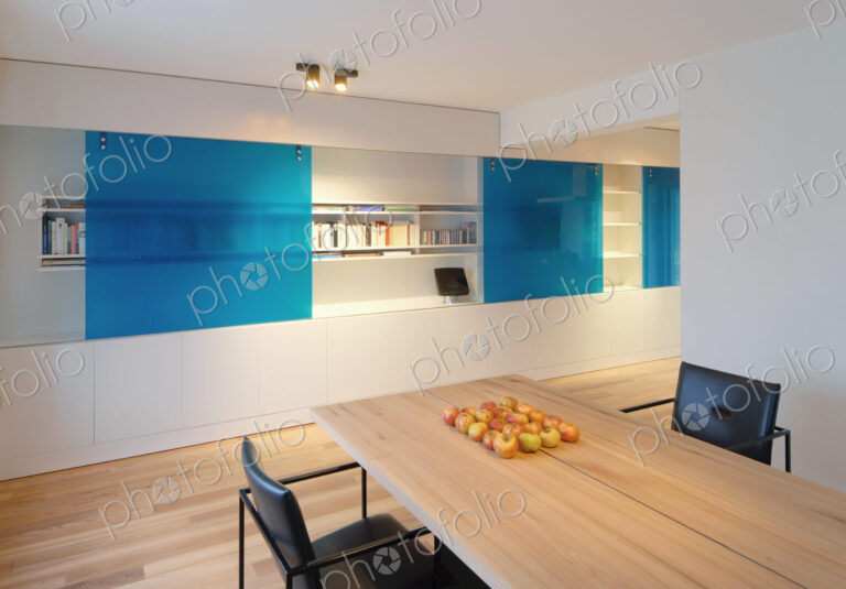 Table and chairs near wall fixtures in modern dining room