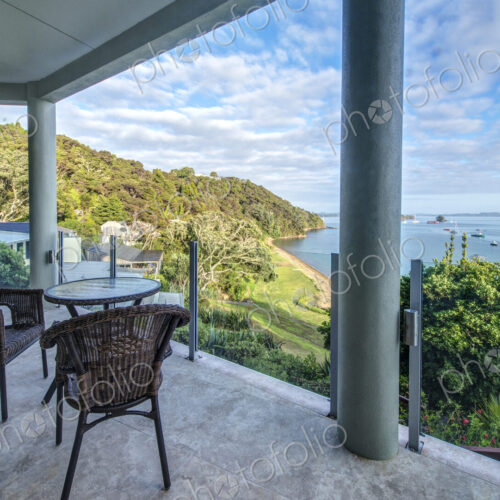 Table and chairs on balcony overlooking Bay of Islands, Paihia, New Zealand Table and chairs on balcony overlooking Bay of Islands, Paihia, New Zealand
