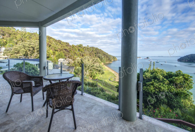 Table and chairs on balcony overlooking Bay of Islands, Paihia, New Zealand