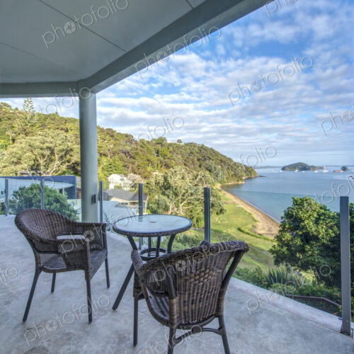 Table and chairs on balcony overlooking Bay of Islands, Paihia, New Zealand Table and chairs on balcony overlooking Bay of Islands, Paihia, New Zealand