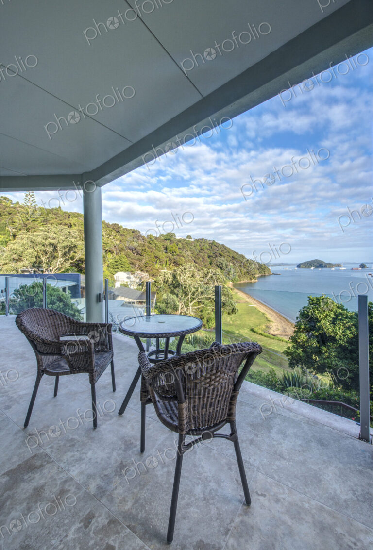 Table and chairs on balcony overlooking Bay of Islands, Paihia, New Zealand