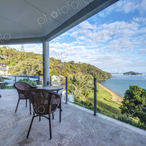 Table and chairs on balcony overlooking Bay of Islands, Paihia, New Zealand Table and chairs on balcony overlooking Bay of Islands, Paihia, New Zealand