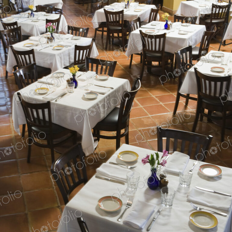 Tables and chairs in empty restaurant