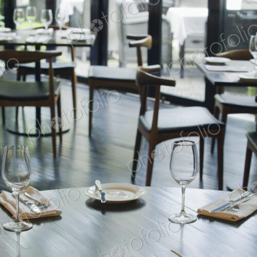 Tables and chairs set for dinner in a restaurant Tables and chairs set for dinner in a restaurant