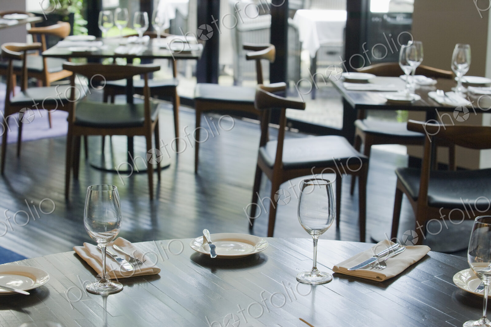 Tables and chairs set for dinner in a restaurant