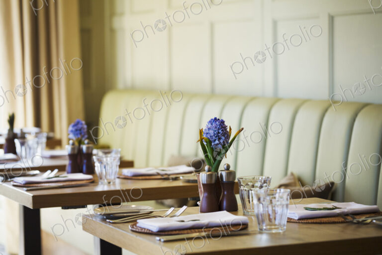 Tables set in the dining room at a boutique hotel in Gloucestershire.