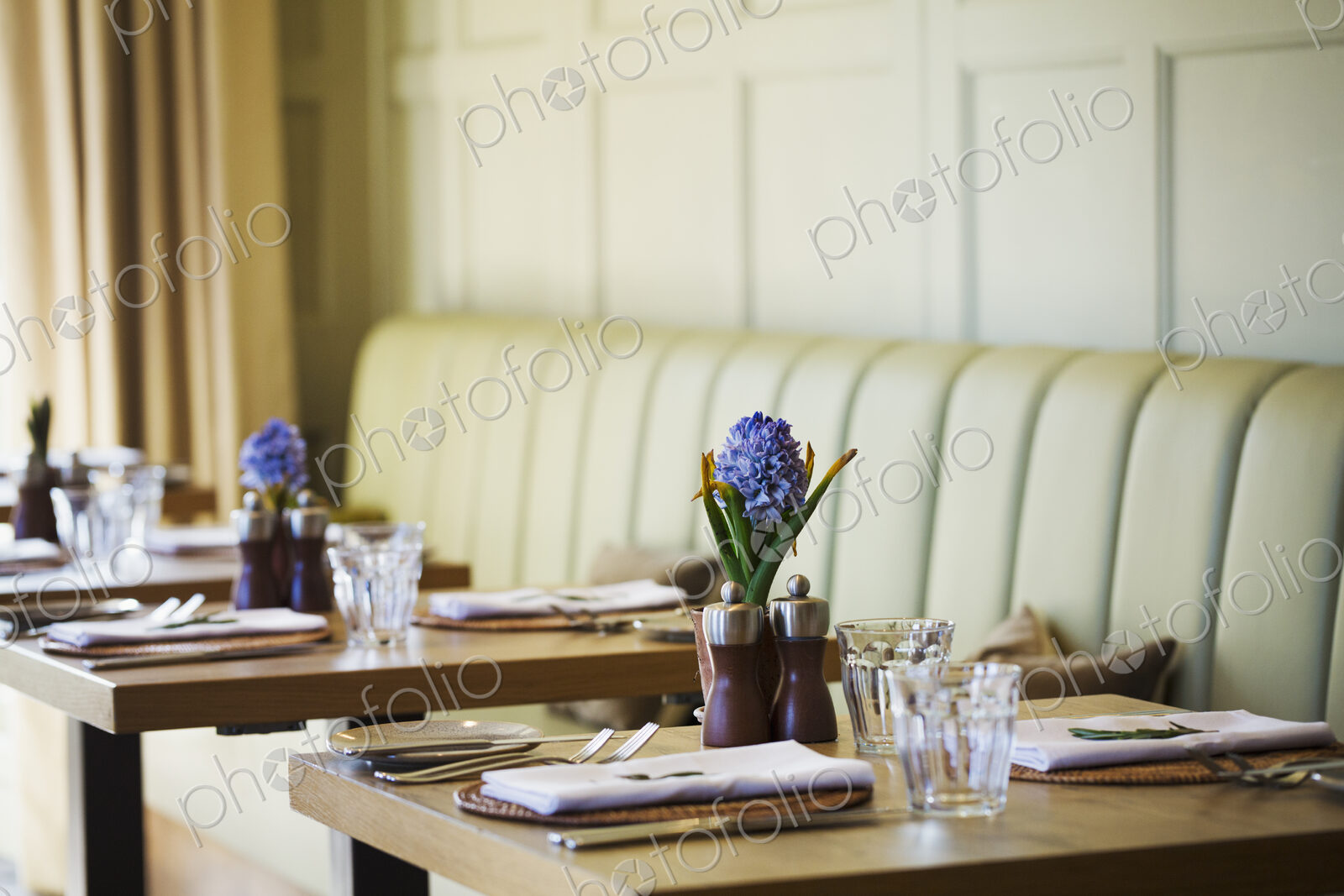 Tables set in the dining room at a boutique hotel in Gloucestershire.