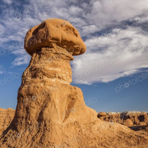 Tall hoodoo rock formation in Goblin Valley State Park, Utah, standing against a deep…