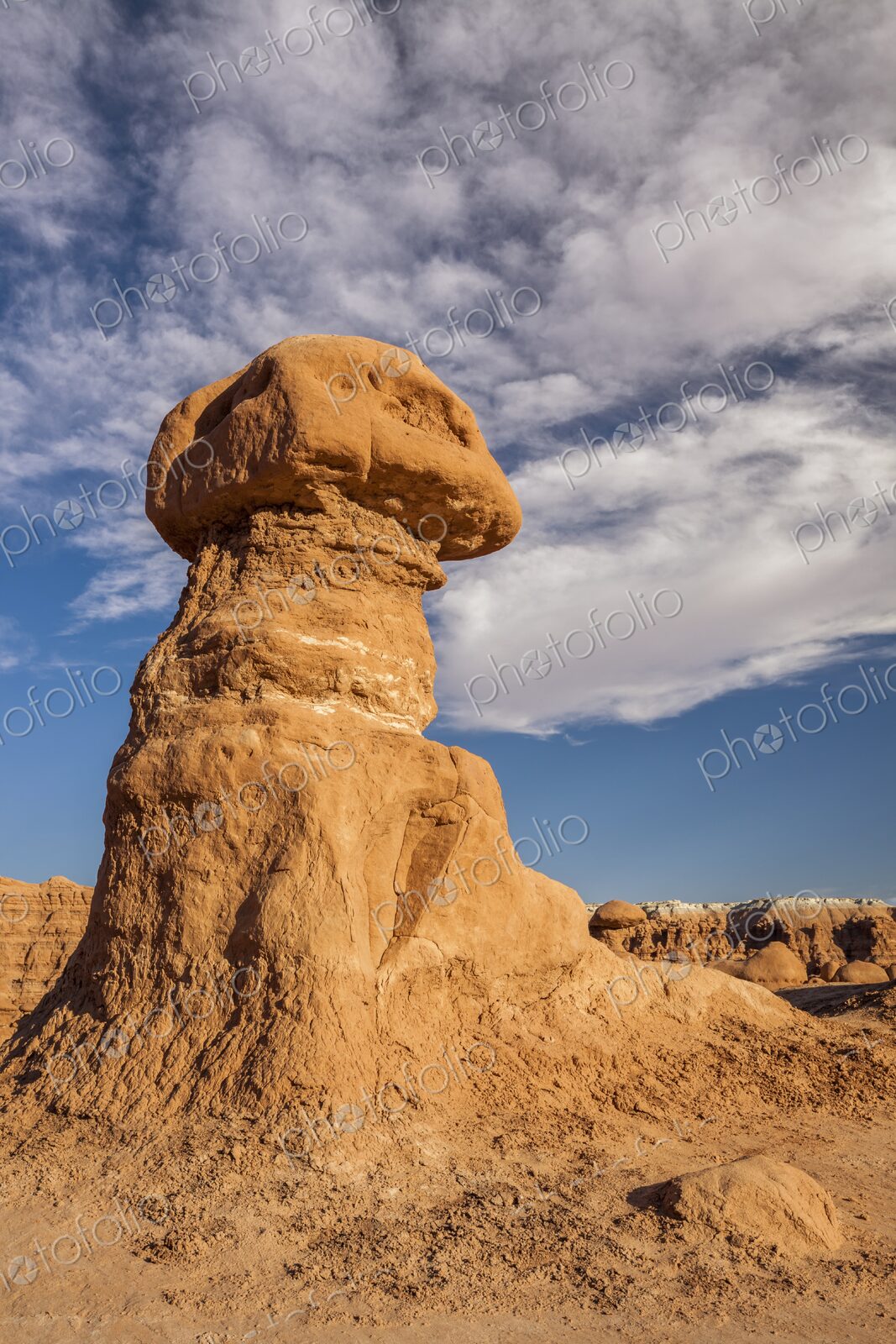 Tall hoodoo rock formation in Goblin Valley State Park, Utah, standing against a deep…