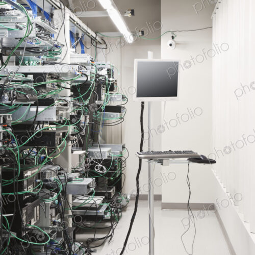 Tangled computer server cords in server room Tangled computer server cords in server room