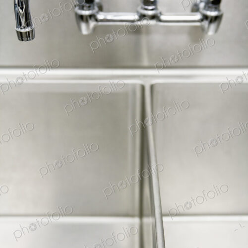 Tap over metal double sink.