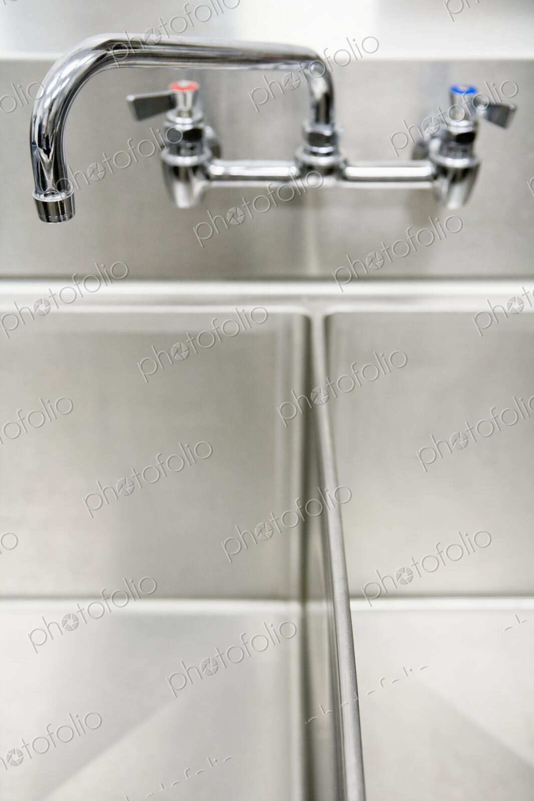 Tap over metal double sink.