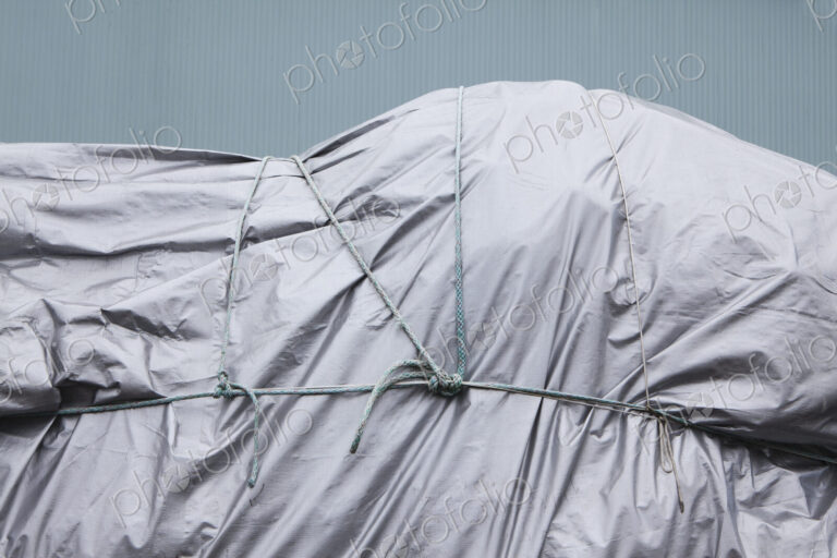 Tarpaulin and rope covering commercial fishing nets at Fisherman's Terminal.