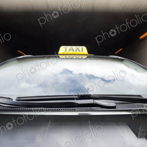 Taxi cab emerging from a garage. Taxi cab emerging from a garage.