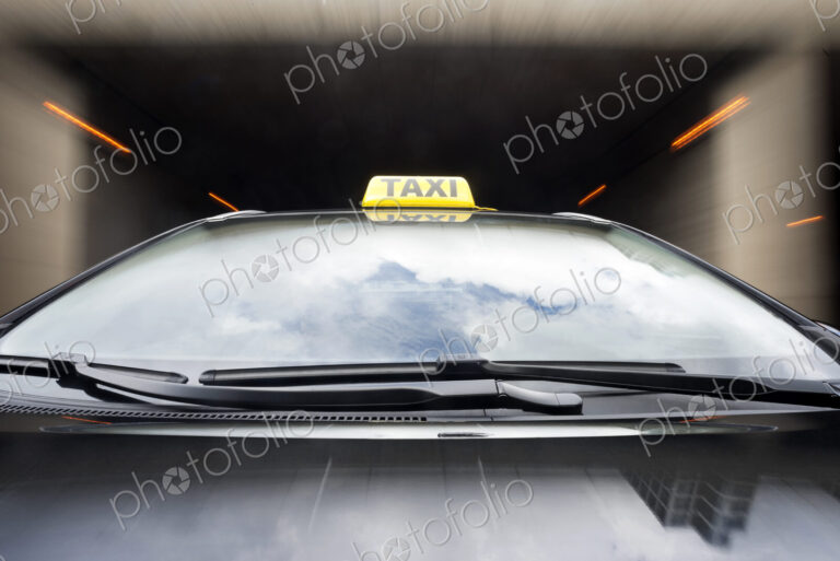 Taxi cab emerging from a garage.