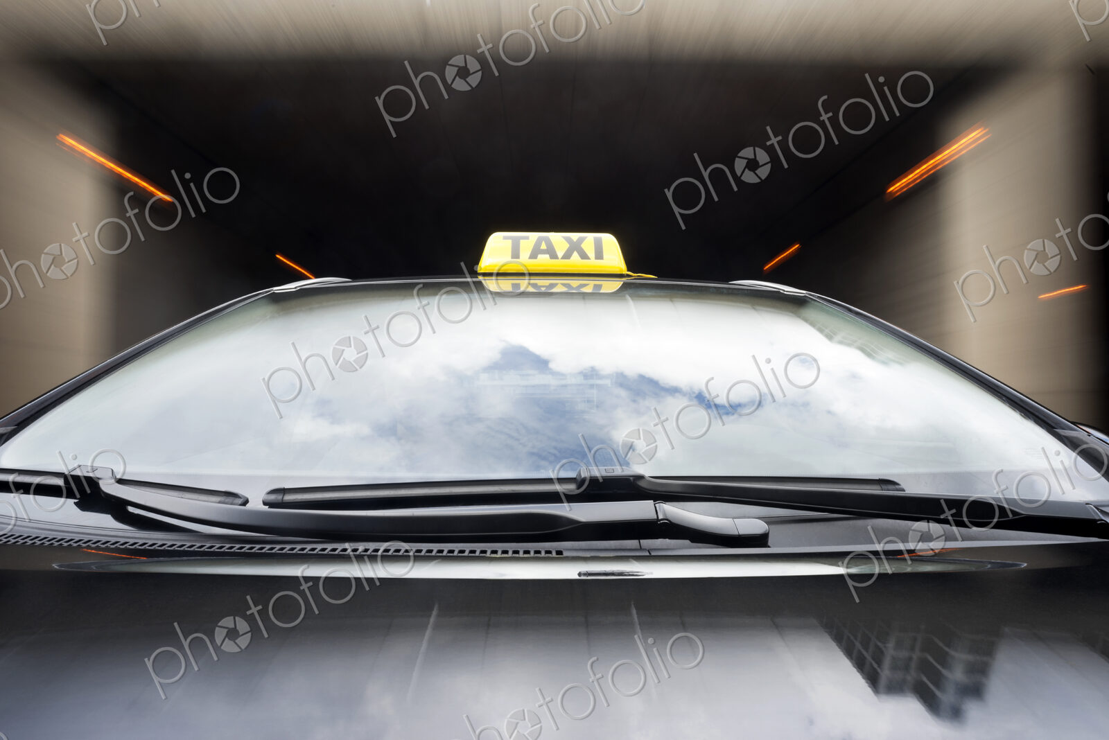 Taxi cab emerging from a garage.