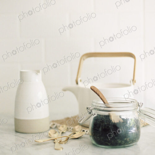 Tea pot, jug and a glass jar with black tea leaves. Tea pot, jug and a glass jar with black tea leaves.