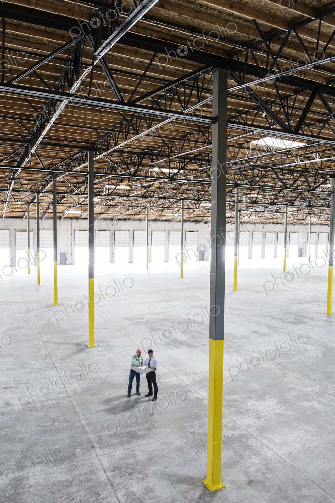 Team of people checking out the new interior of an empty warehouse space.