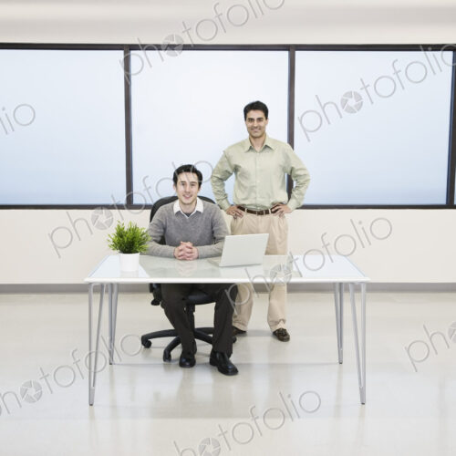 Team of two caucasian businessmen in a computer server farm office. Team of two caucasian businessmen in a computer server farm office.