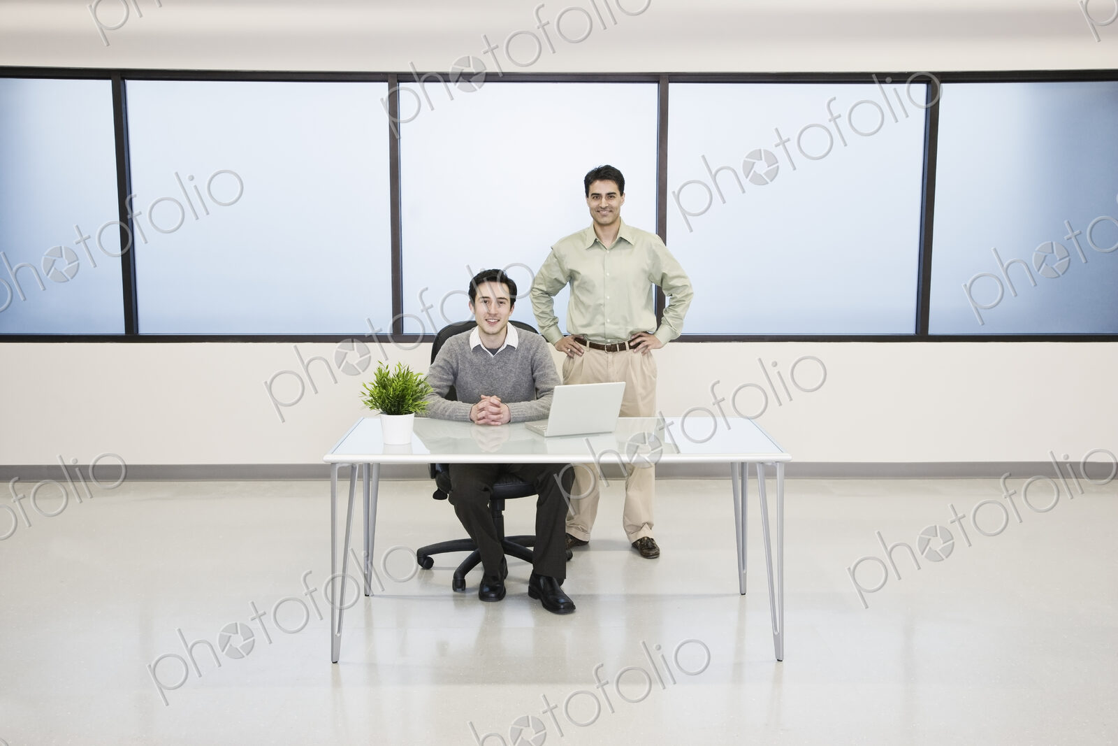 Team of two caucasian businessmen in a computer server farm office.