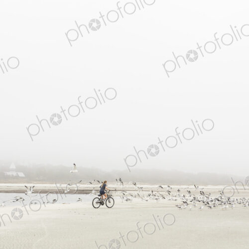 Teen girl biking on sand at the beach, St. Simon's Island Georgia Teen girl biking on sand at the beach, St. Simon's Island Georgia