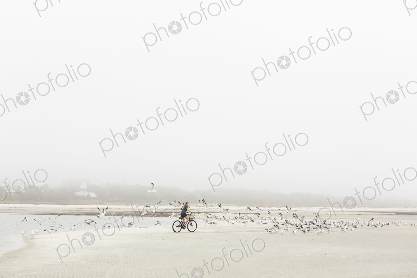 Teen girl biking on sand at the beach, St. Simon’s Island Georgia