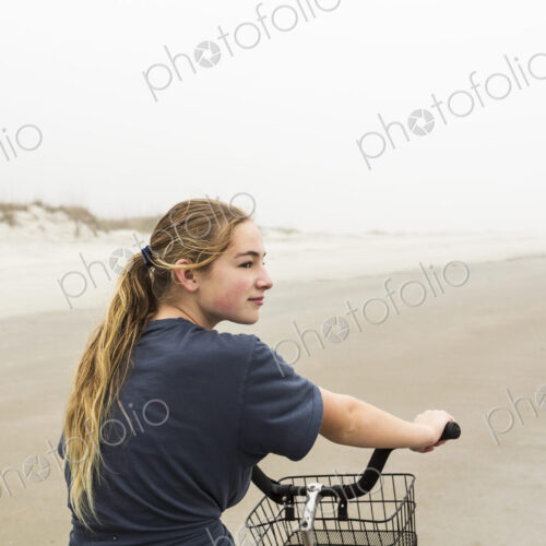 Teen girl biking on sand at the beach, St. Simon's Island Georgia Teen girl biking on sand at the beach, St. Simon's Island Georgia