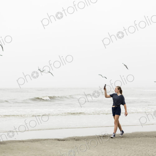 Teen girl talking pictures with smart phone at the beach, St. Simon's Island, Georgia Teen girl talking pictures with smart phone at the beach, St. Simon's Island, Georgia