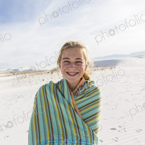Teenage girl in a towel on the sand, White Sands Nat'l Monument, NM Teenage girl in a towel on the sand, White Sands Nat'l Monument, NM