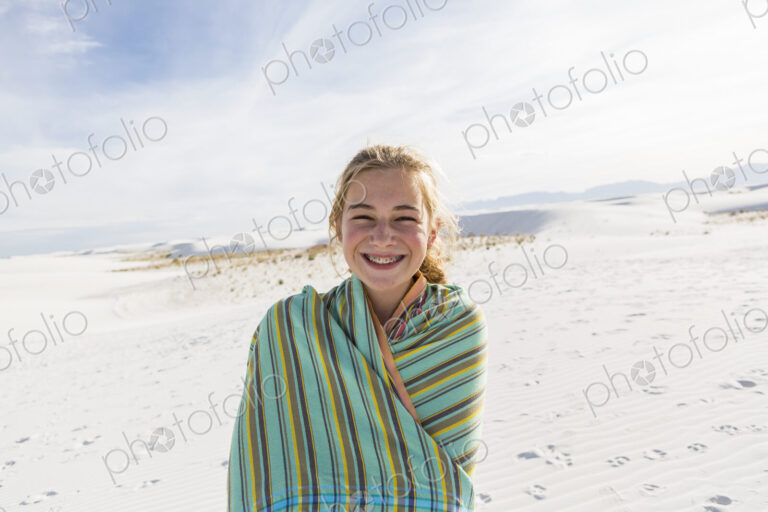 Teenage girl in a towel on the sand, White Sands Nat'l Monument, NM
