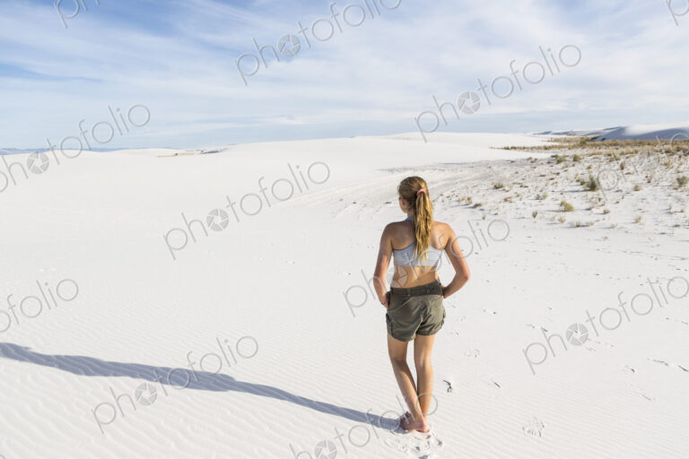 Teenage girl looking over the landscape at White Sands Nat'l Monument, NM