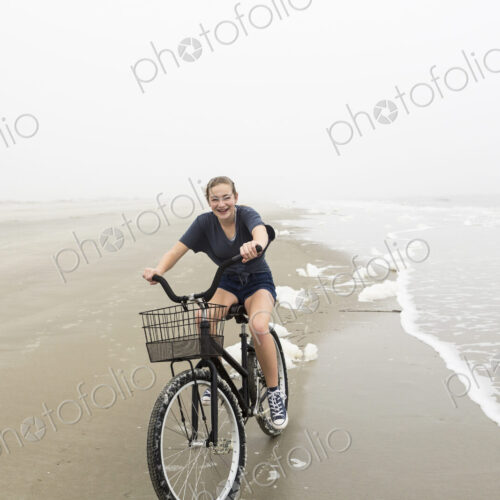 Teenage girl riding a bike on sand at the beach, St. Simon's Island Georgia Teenage girl riding a bike on sand at the beach, St. Simon's Island Georgia