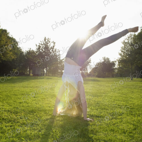 Teenage girl with long blond hair doing a headstand. Teenage girl with long blond hair doing a headstand.