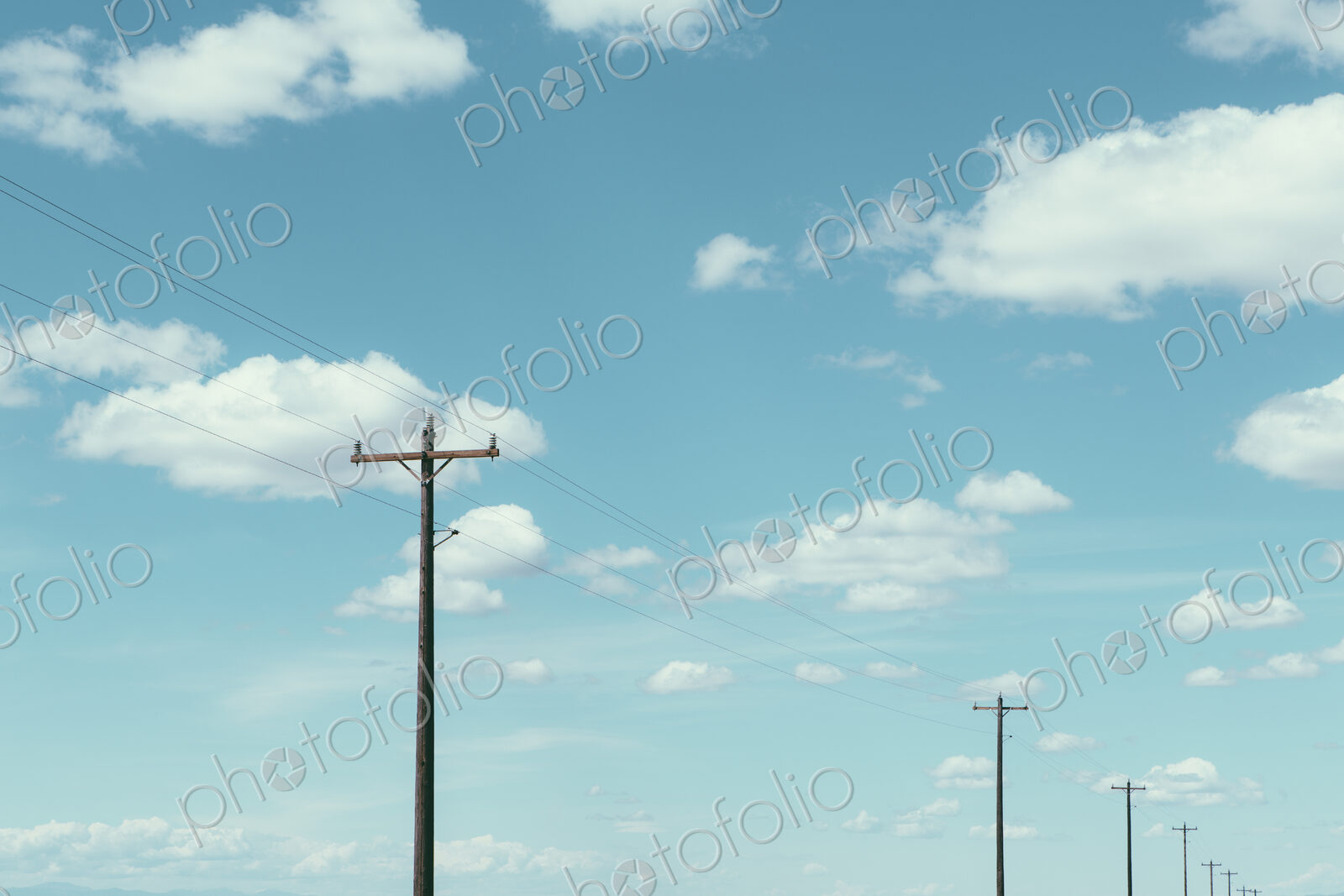 Telephone poles, power lines and cloudy sky, near Quincy
