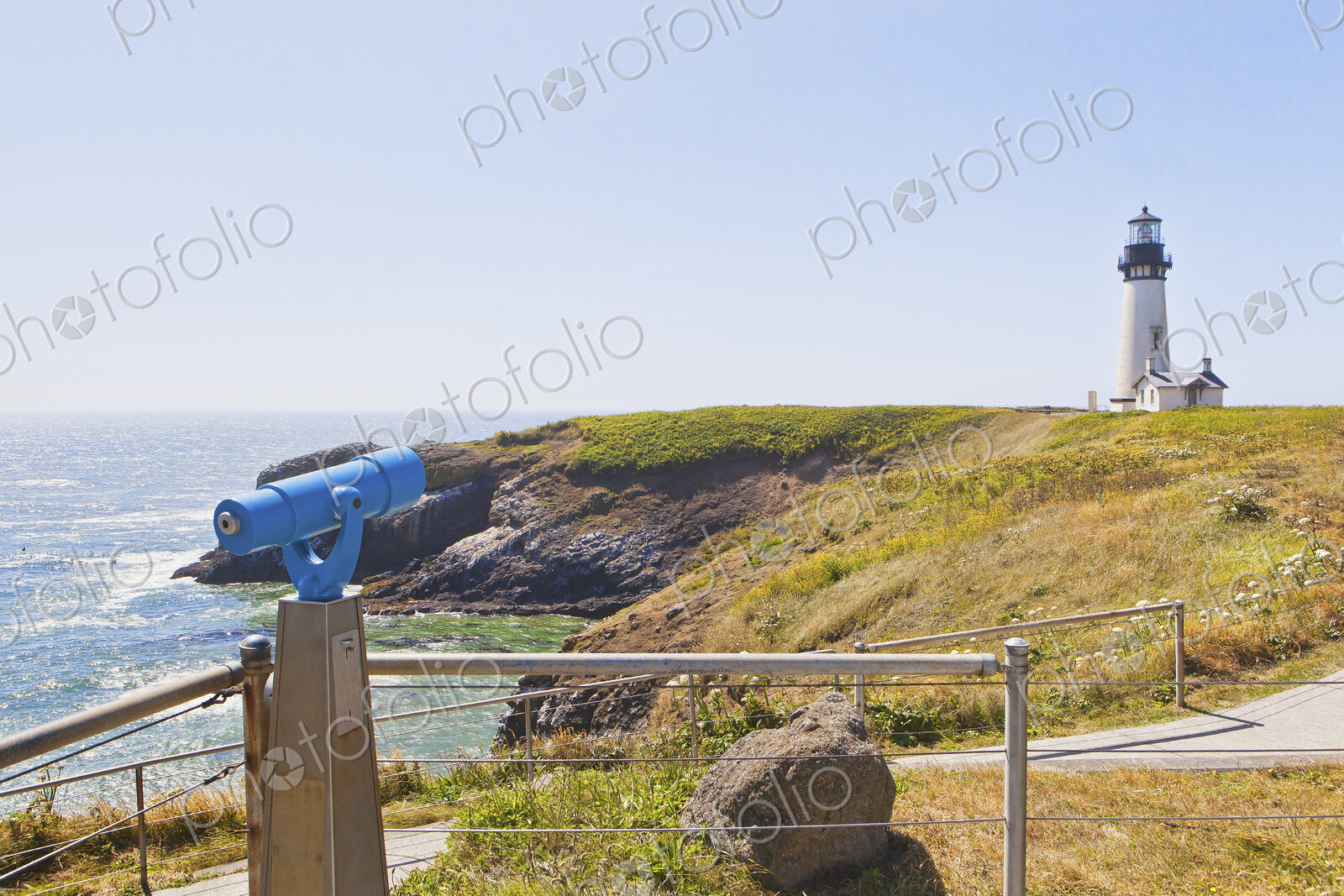 Telescope overlooking lighthouse on cliff, Newport, Oregon, United States