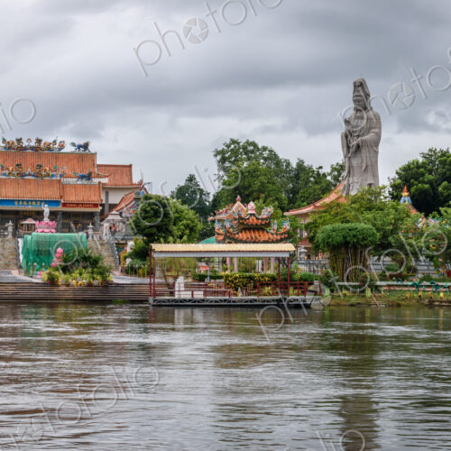 Temple and tall statue along a river in Koh Samui. Temple and tall statue along a river in Koh Samui.