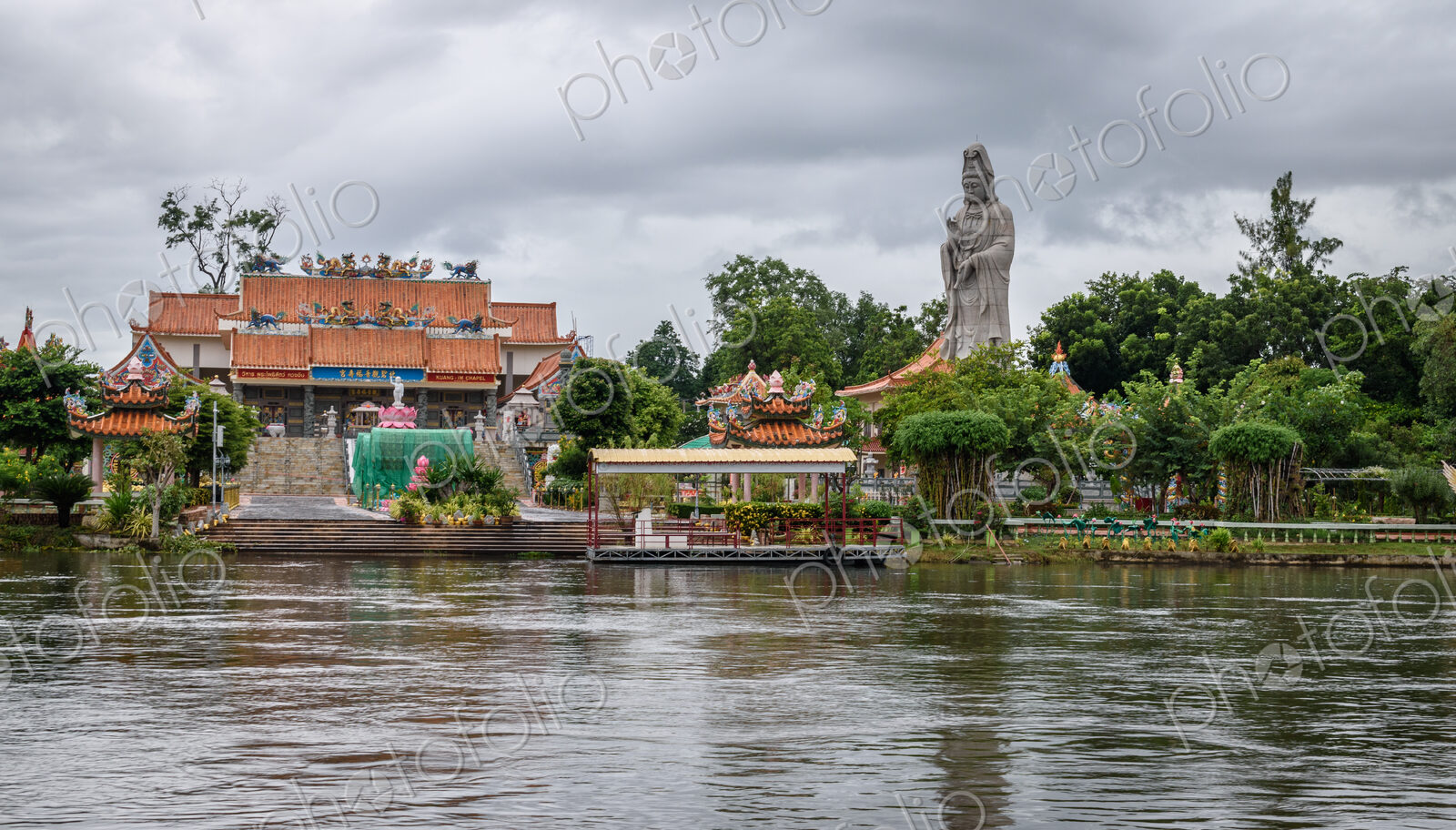 Temple and tall statue along a river in Koh Samui.